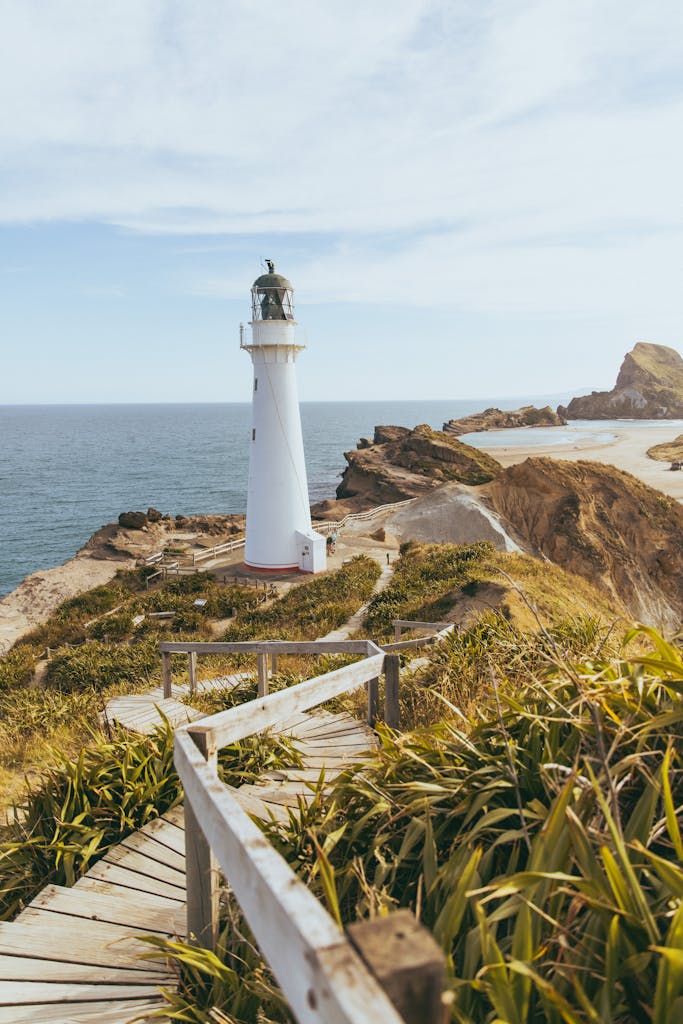 Scenic view of Castlepoint lighthouse and rugged coastline in New Zealand.
